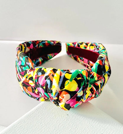 Colorful patterned headband on a white surface