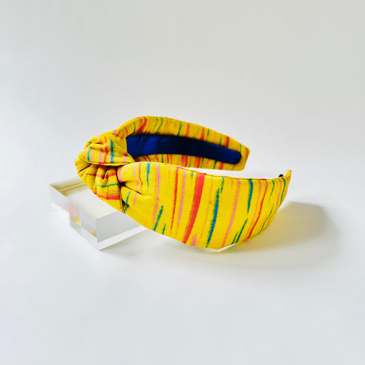 Yellow headband with colorful stripes on a white background