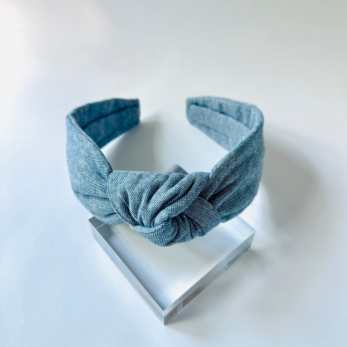 Blue denim headband on a white background