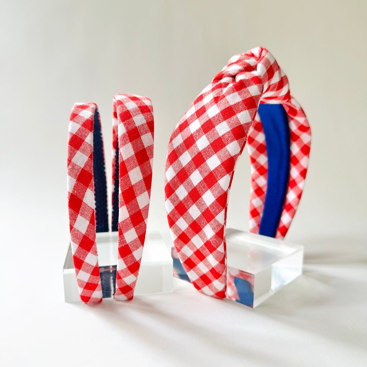 Red and white checkered headbands with blue accents on a white background
